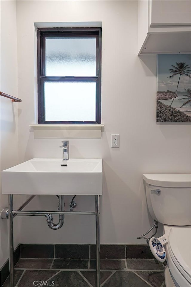 bathroom featuring toilet and sink