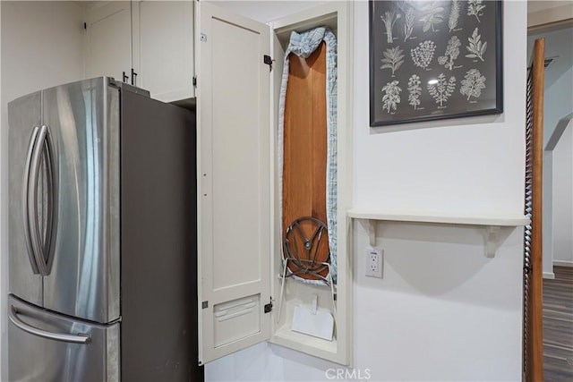 interior space with white cabinetry and stainless steel fridge