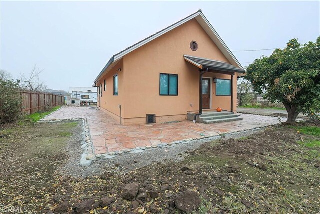 rear view of property featuring a patio