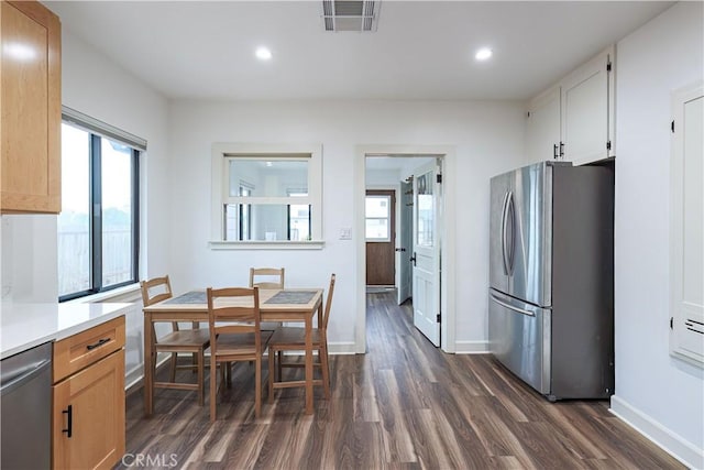 dining area with dark hardwood / wood-style floors and a wealth of natural light