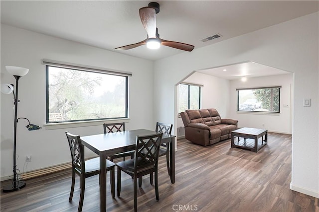 dining area featuring dark wood-type flooring and ceiling fan