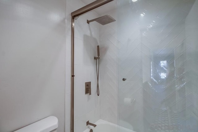 bathroom with toilet and enclosed tub / shower combo