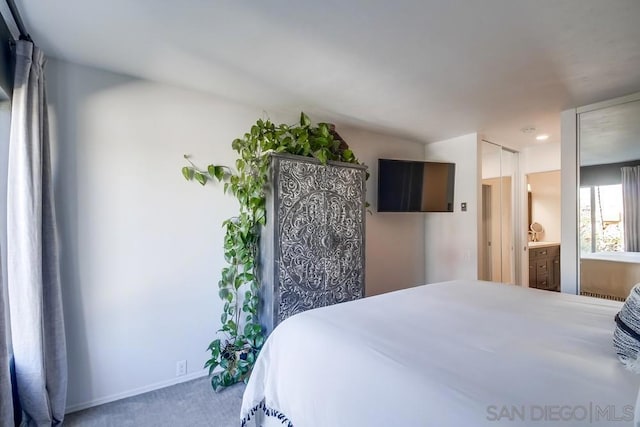 bedroom featuring carpet and ensuite bath