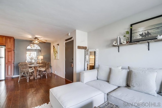 living room with ceiling fan and dark hardwood / wood-style floors