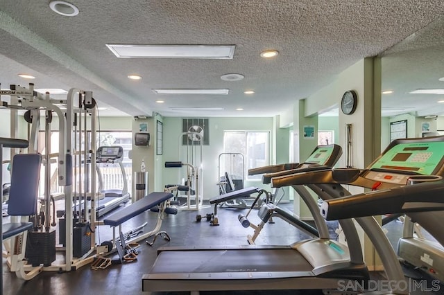 exercise room featuring plenty of natural light and a textured ceiling