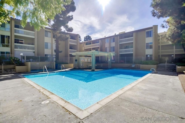 view of pool with a pergola and a patio area