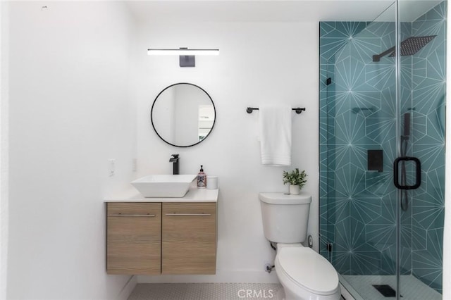 bathroom featuring a shower with door, tile patterned floors, toilet, and vanity