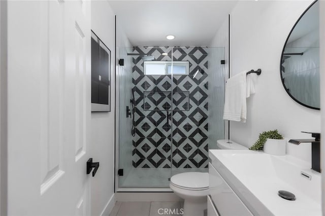 bathroom featuring vanity, toilet, tile patterned floors, and an enclosed shower