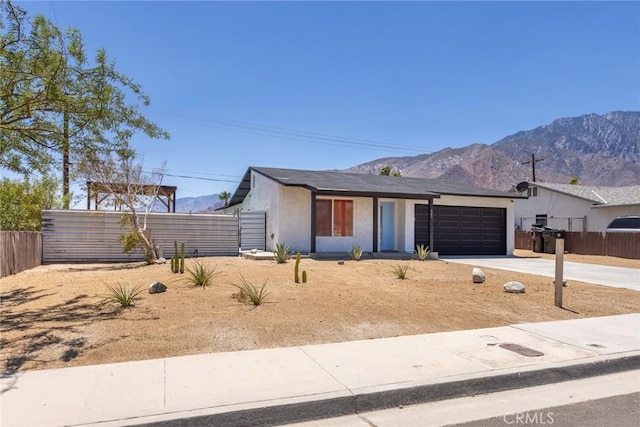 view of front of property featuring a mountain view and a garage