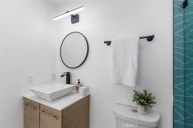 bathroom featuring toilet and vanity