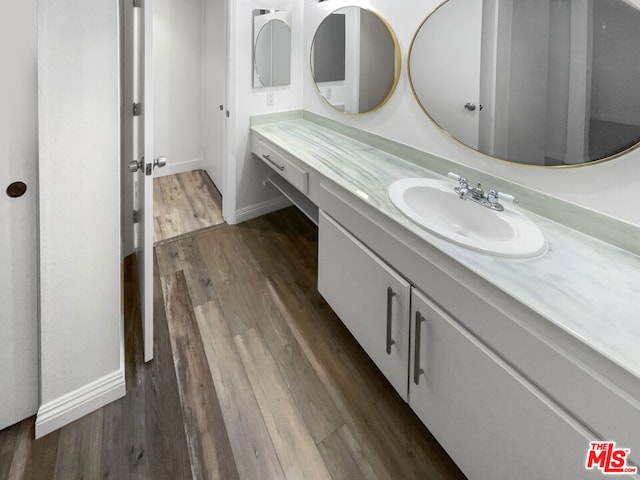 bathroom with hardwood / wood-style flooring and vanity