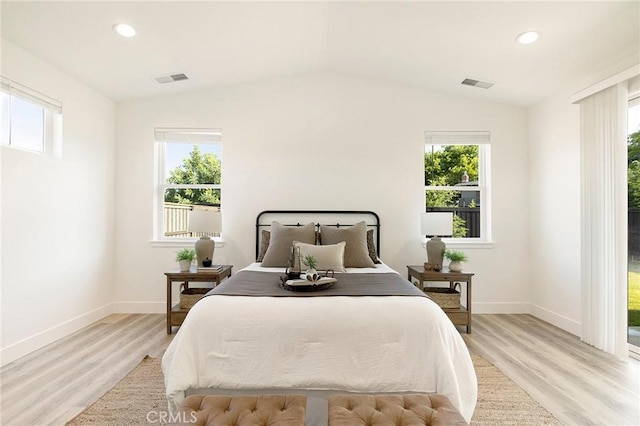 bedroom with light hardwood / wood-style flooring and lofted ceiling