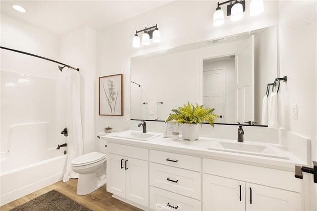 full bathroom featuring toilet, vanity, shower / tub combo with curtain, and hardwood / wood-style flooring