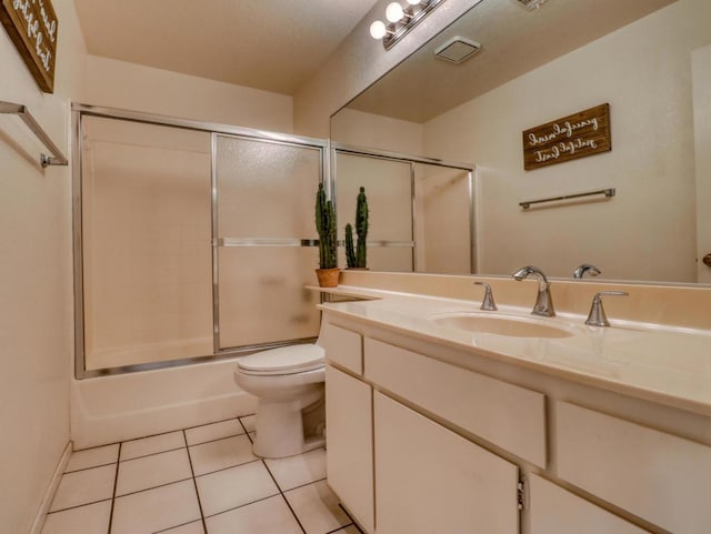 full bathroom with toilet, bath / shower combo with glass door, tile patterned floors, and vanity