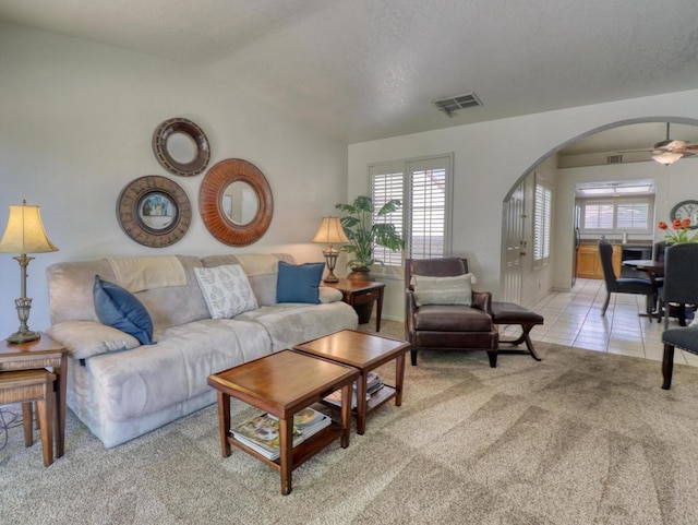 tiled living room featuring ceiling fan