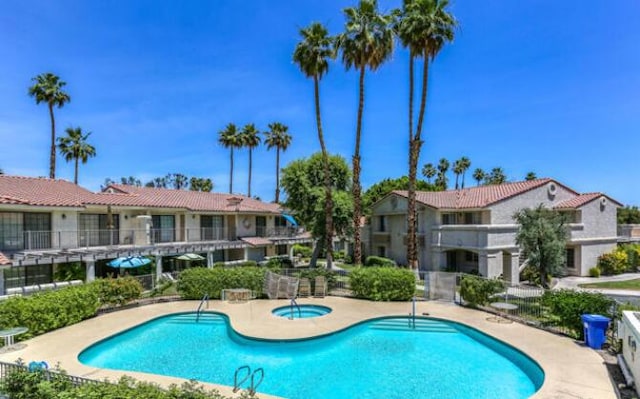 view of swimming pool featuring a community hot tub