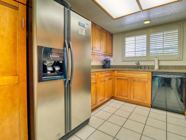 kitchen with stainless steel refrigerator with ice dispenser, light tile patterned floors, dishwasher, and sink