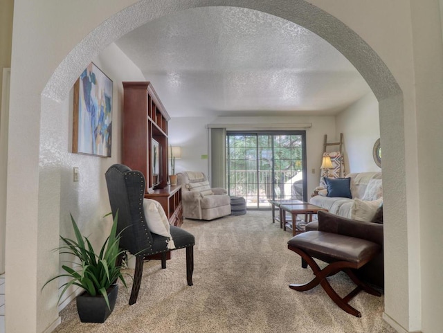 living room with light carpet and a textured ceiling