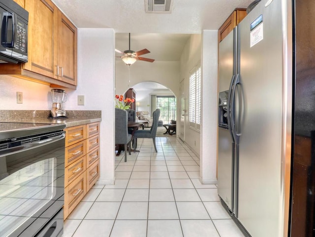 kitchen with black appliances, ceiling fan, and light tile patterned flooring