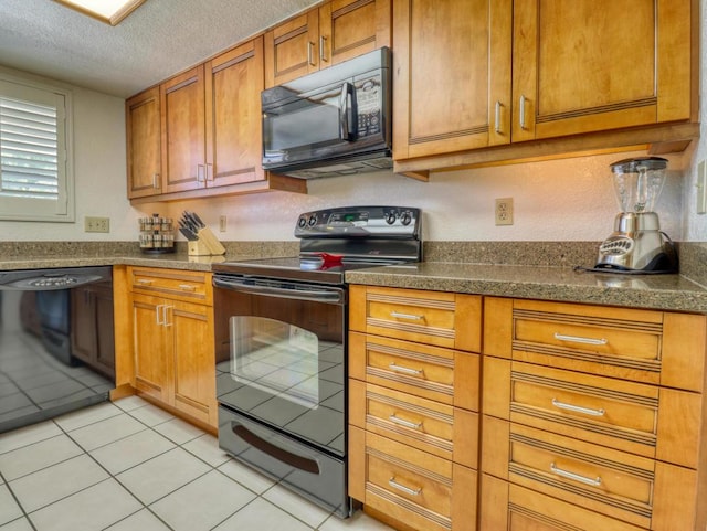 kitchen featuring a textured ceiling, black appliances, and light tile patterned flooring