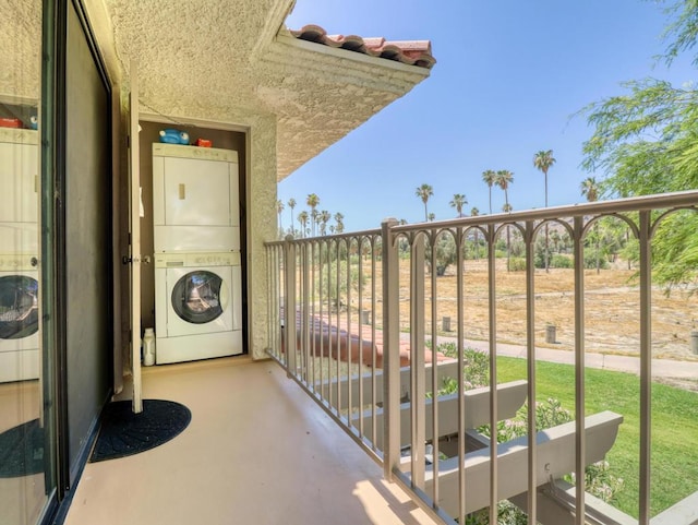 balcony featuring stacked washer and clothes dryer