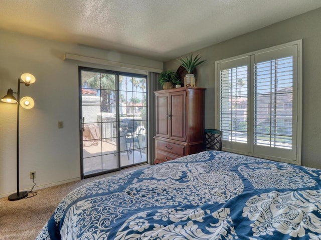 bedroom featuring a textured ceiling, carpet, and access to outside