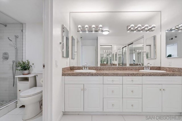 bathroom with tile patterned floors, toilet, walk in shower, and vanity