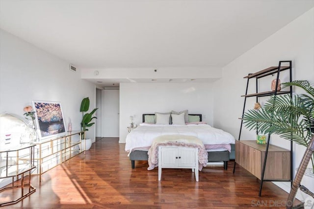 bedroom with dark hardwood / wood-style flooring