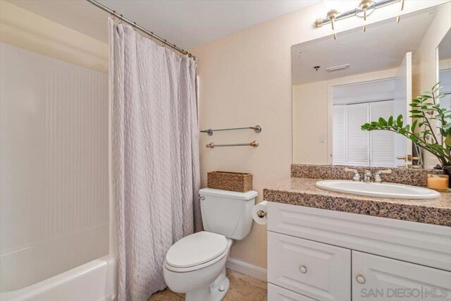 full bathroom with toilet, vanity, and shower / bath combination with curtain