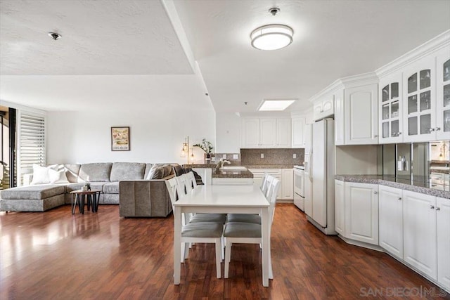 dining area with sink and dark hardwood / wood-style floors