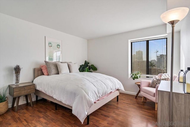 bedroom with dark wood-type flooring