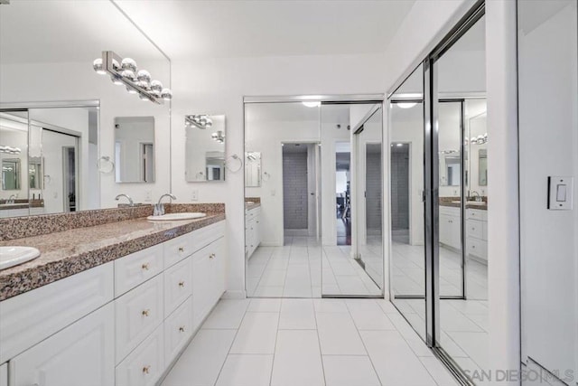 bathroom with tile patterned floors and vanity