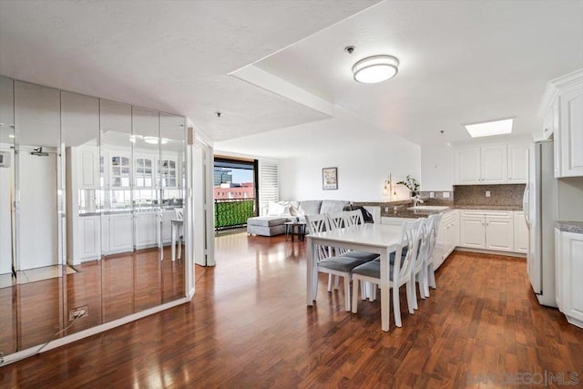 dining space with sink and dark hardwood / wood-style flooring