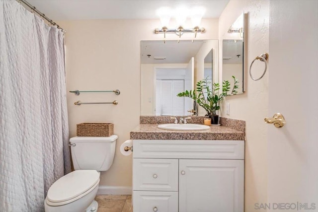 bathroom featuring toilet, vanity, and tile patterned floors