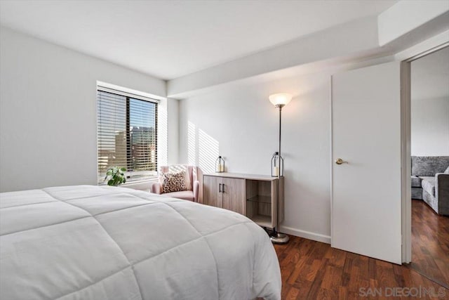 bedroom with dark wood-type flooring