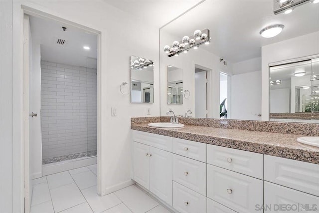 bathroom with vanity, tile patterned floors, and tiled shower