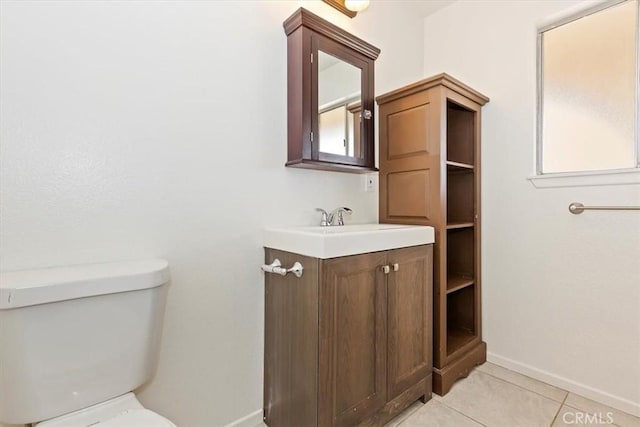 bathroom featuring tile patterned floors, vanity, and toilet