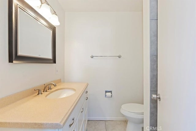 bathroom featuring vanity, tile patterned floors, and toilet