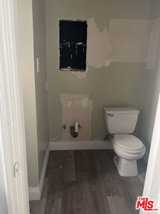 bathroom with toilet and hardwood / wood-style flooring