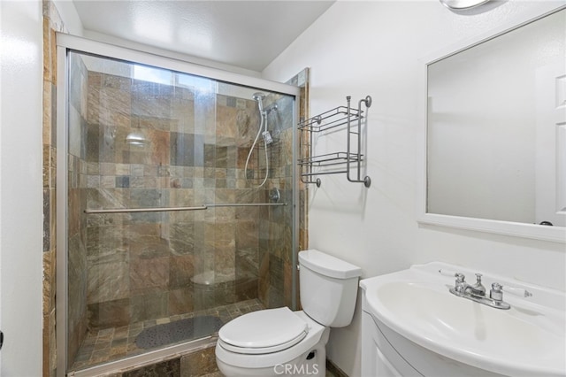 bathroom with toilet, an enclosed shower, and vanity