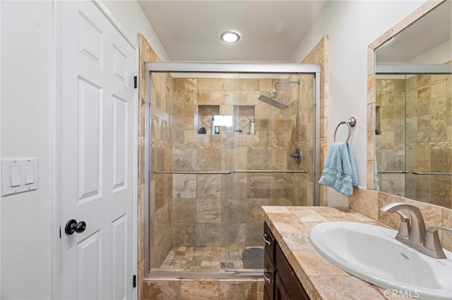 bathroom featuring an enclosed shower and vanity