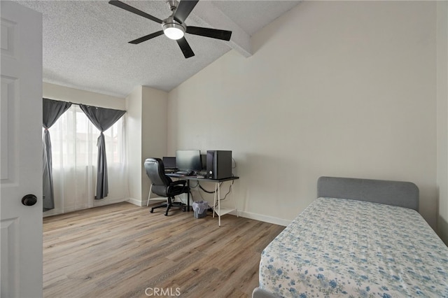 bedroom featuring ceiling fan, lofted ceiling with beams, and hardwood / wood-style floors