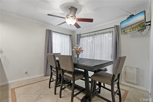 dining space featuring ceiling fan, light tile patterned floors, and crown molding