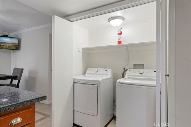 washroom with separate washer and dryer and ornamental molding