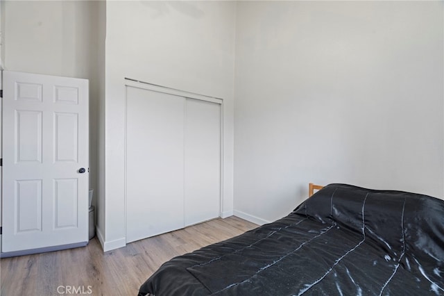 bedroom with wood-type flooring and a closet