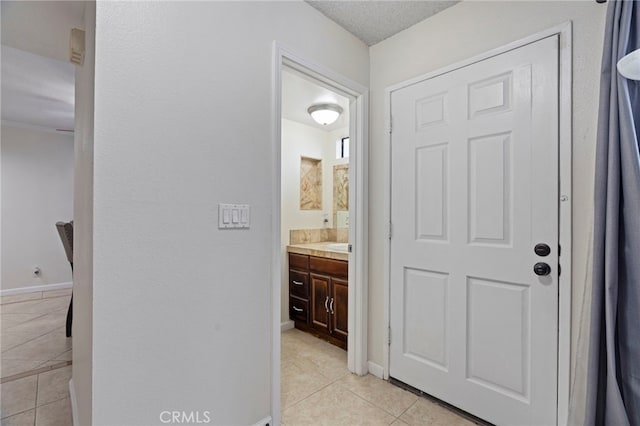 bathroom with tile patterned floors and vanity