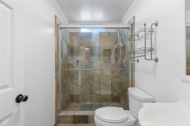 bathroom with toilet and walk in shower