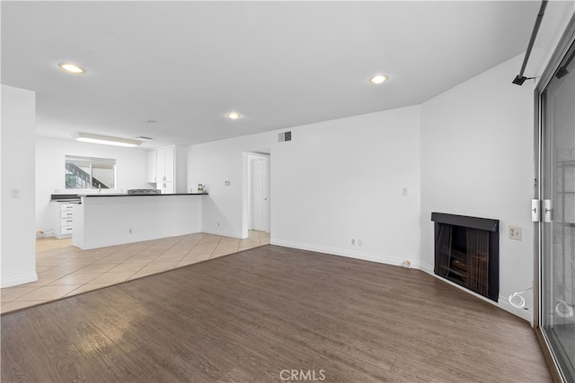 unfurnished living room featuring light hardwood / wood-style flooring