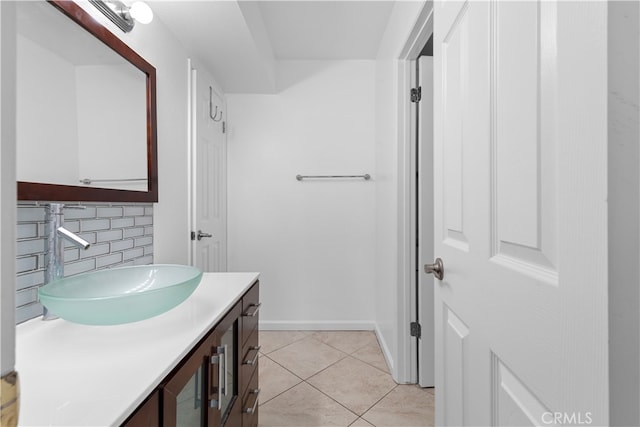 bathroom with tile patterned flooring, decorative backsplash, and vanity