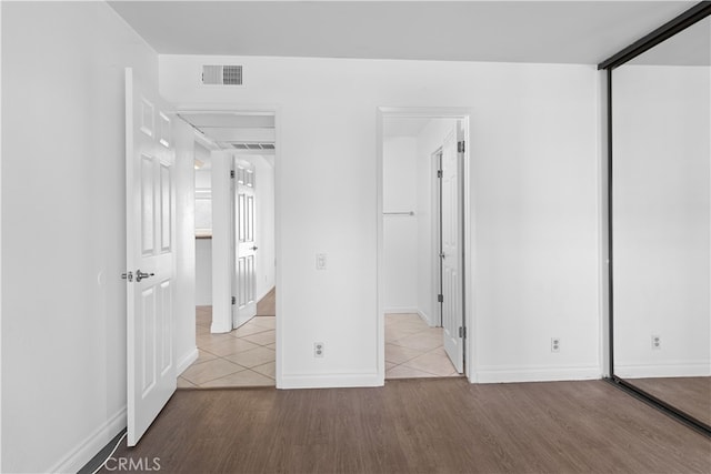 unfurnished bedroom featuring a closet and light hardwood / wood-style floors